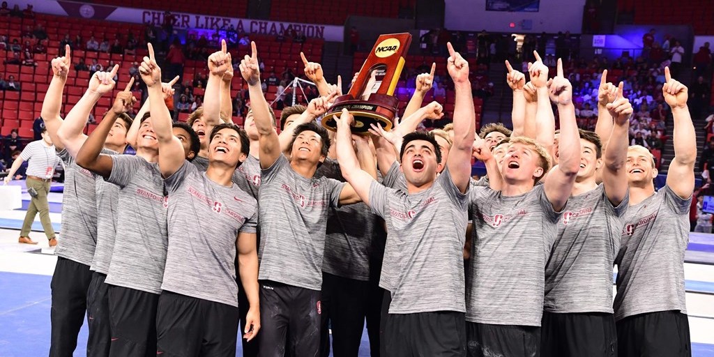 the Stanford men's gymnastics team holds the NCAA championship trophy